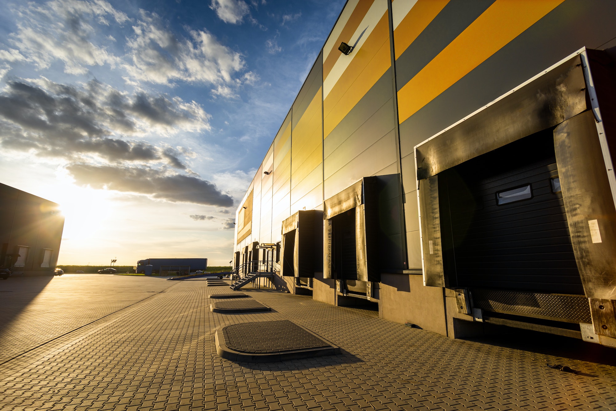 Cargo loading dock doors of big warehouse building, outdoor